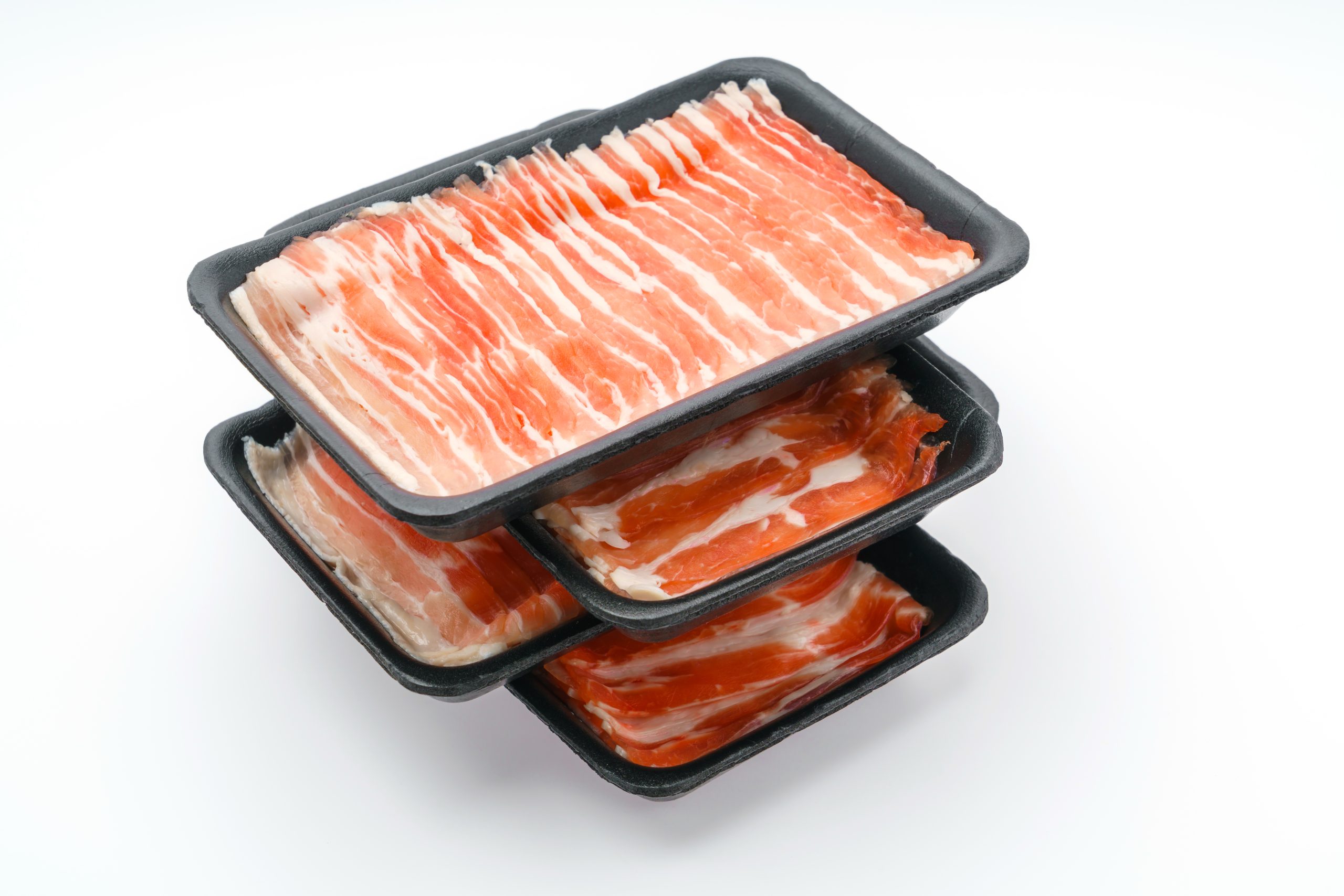 4 stacked trays with sliced pork